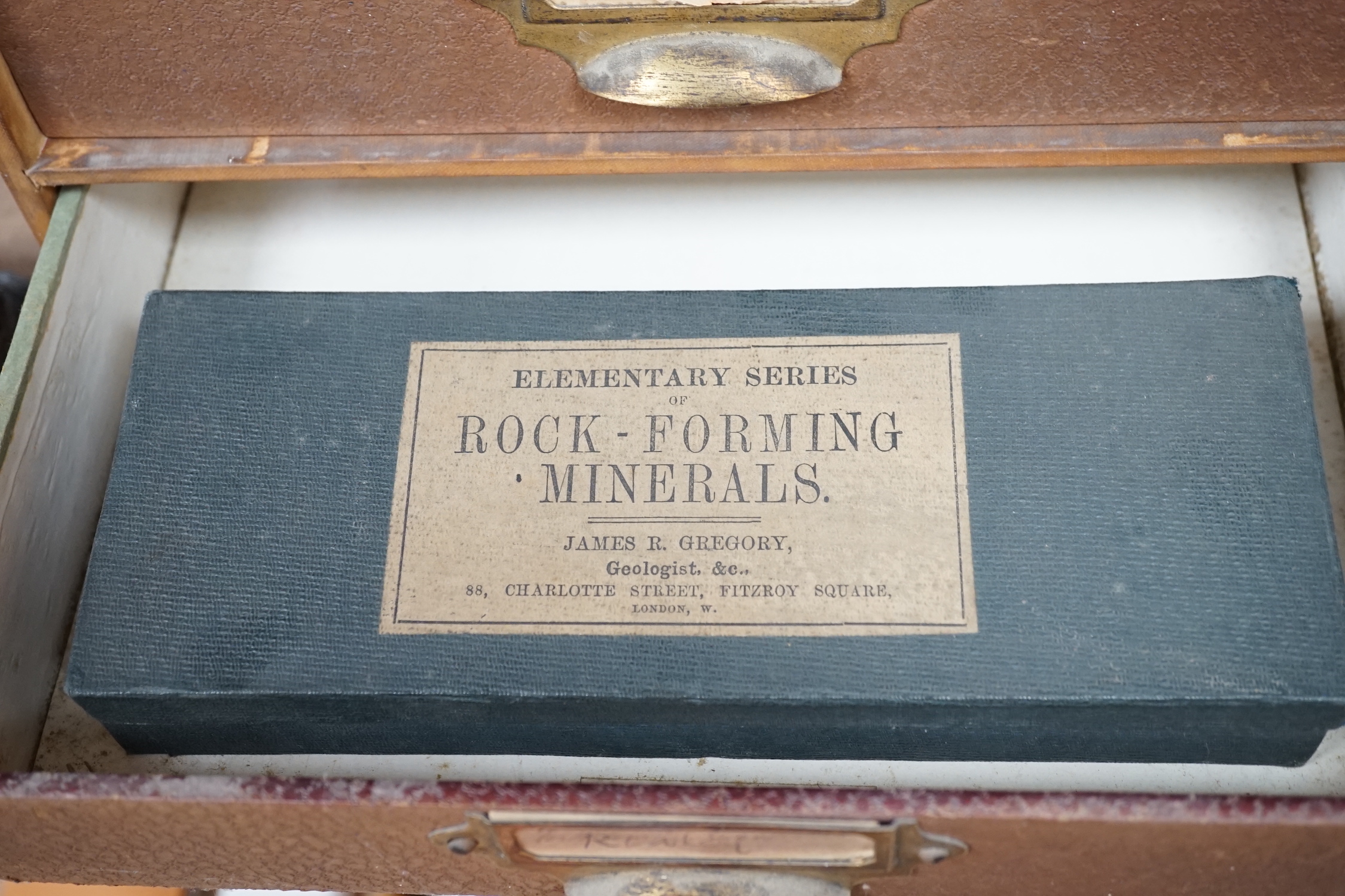 James R. Gregory. Elementary rocks and rock formed minerals, a collection divided between five labelled boxes, in a four drawer desk top filing case